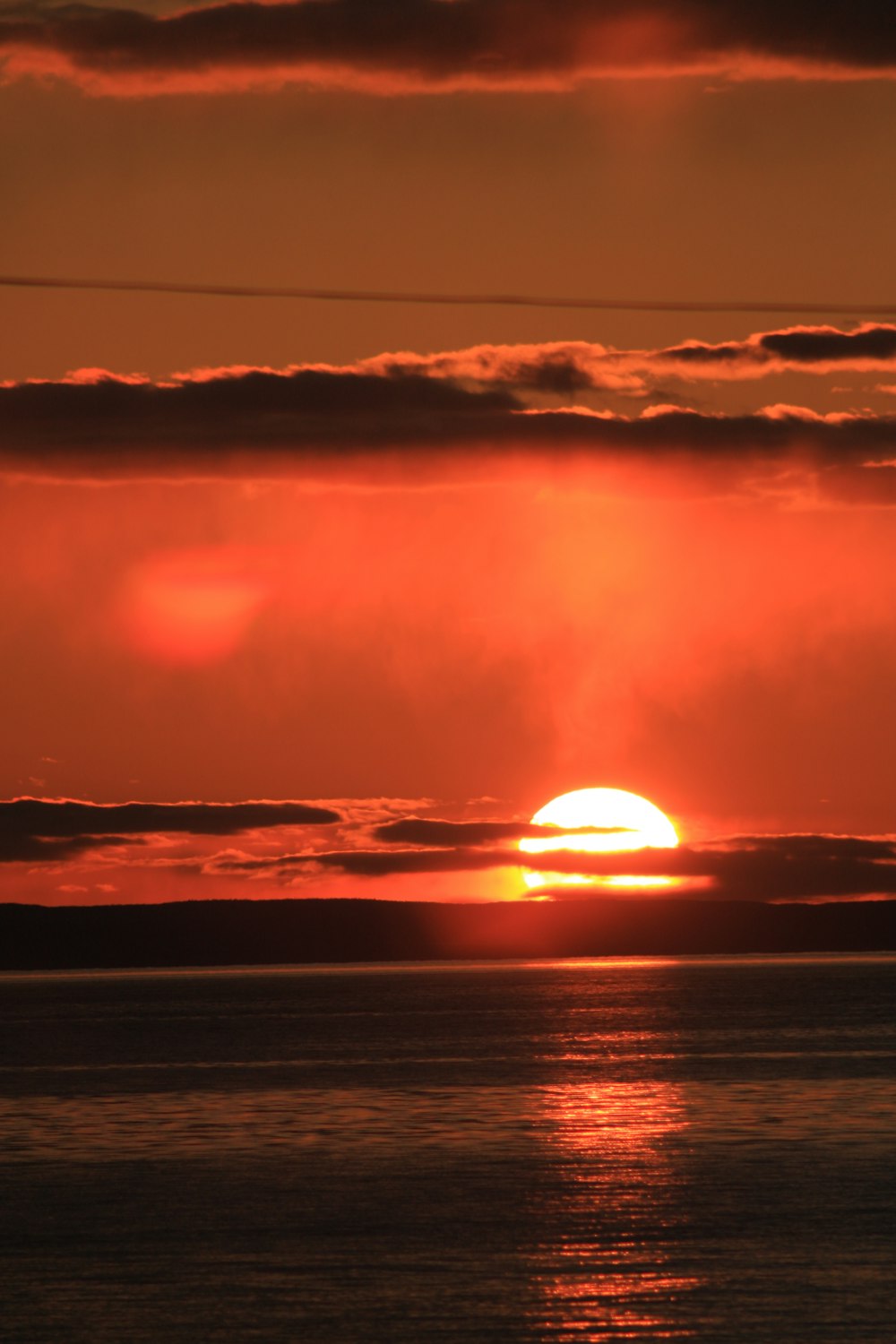 the sun is setting over a body of water