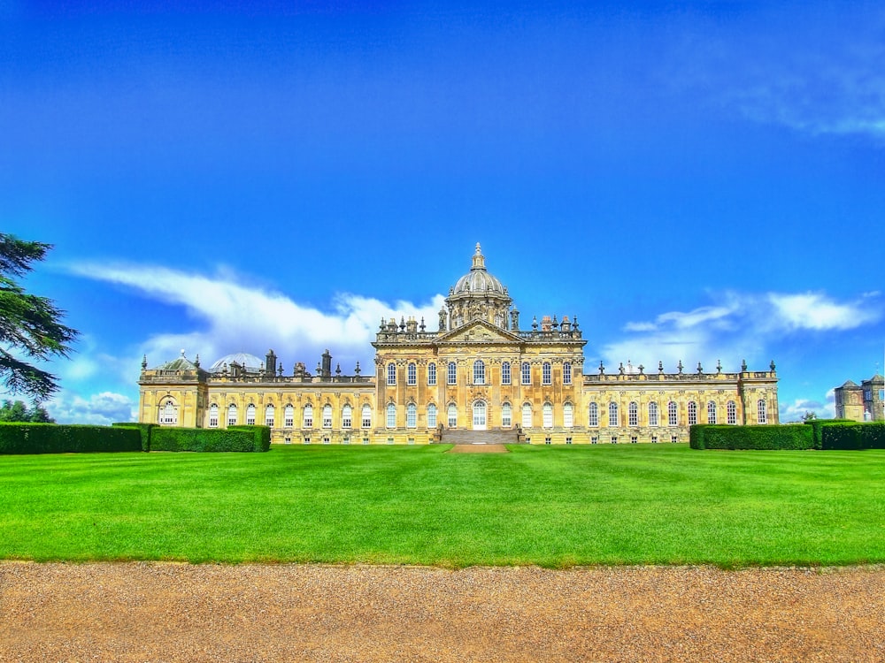 a large building sitting on top of a lush green field