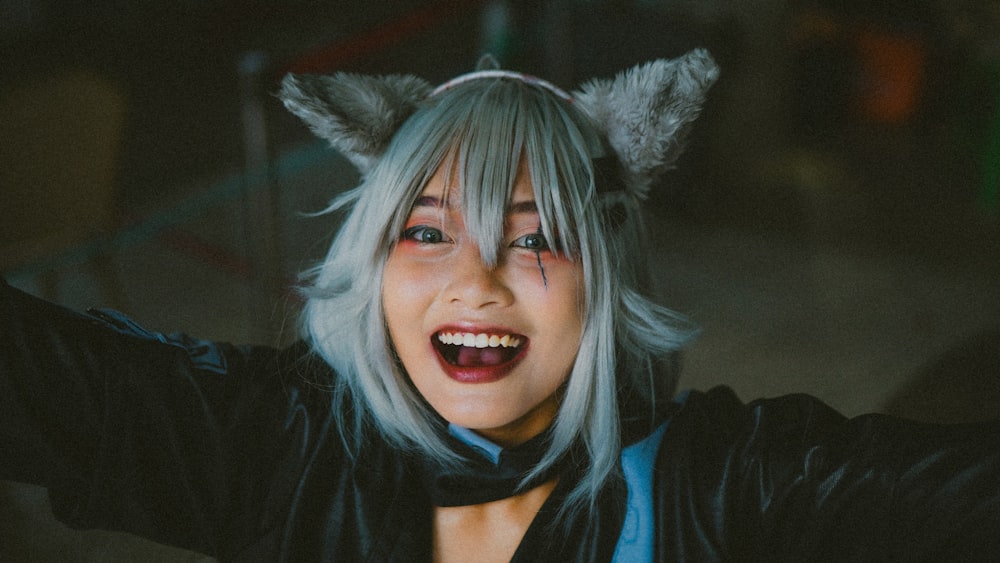 a woman with white hair wearing a cat costume