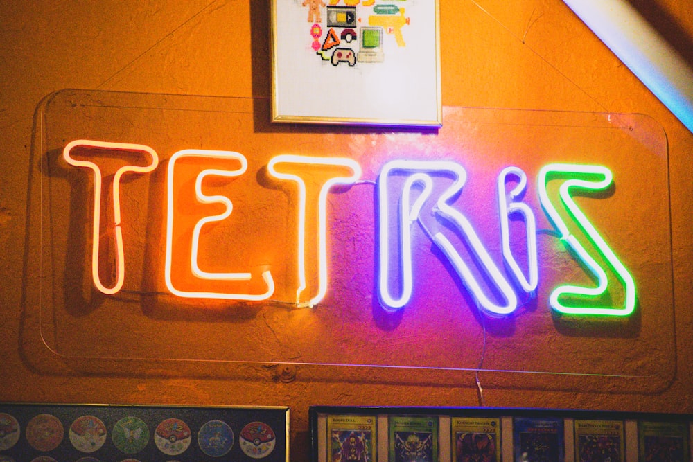 a neon sign that reads tetries on a wall