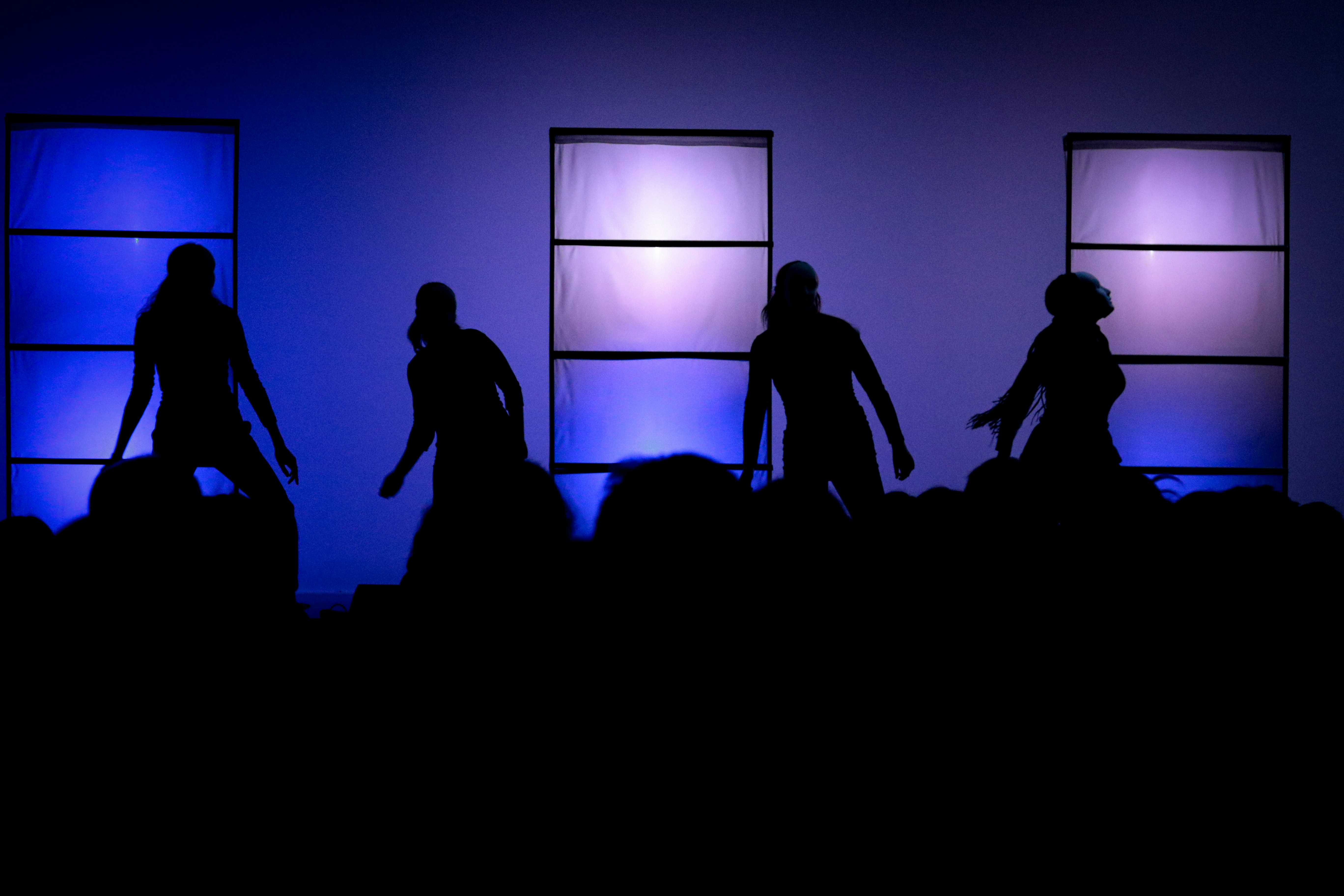 a group of people that are standing in the dark