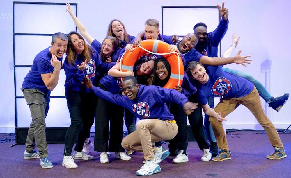 a group of people posing for a picture with a life preserver