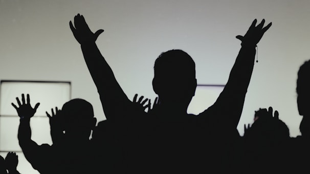 Hands raised in worship, showing unity across generations.
