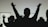 Silhouettes of people raising their hands against a light background, conveying a sense of unity or celebration.