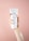 A hand holding a tube of white body cream labeled 'PLANTADEA Bio Crema Corpo' against a soft pink background. There is a dab of cream applied on the forearm of the hand holding the tube.