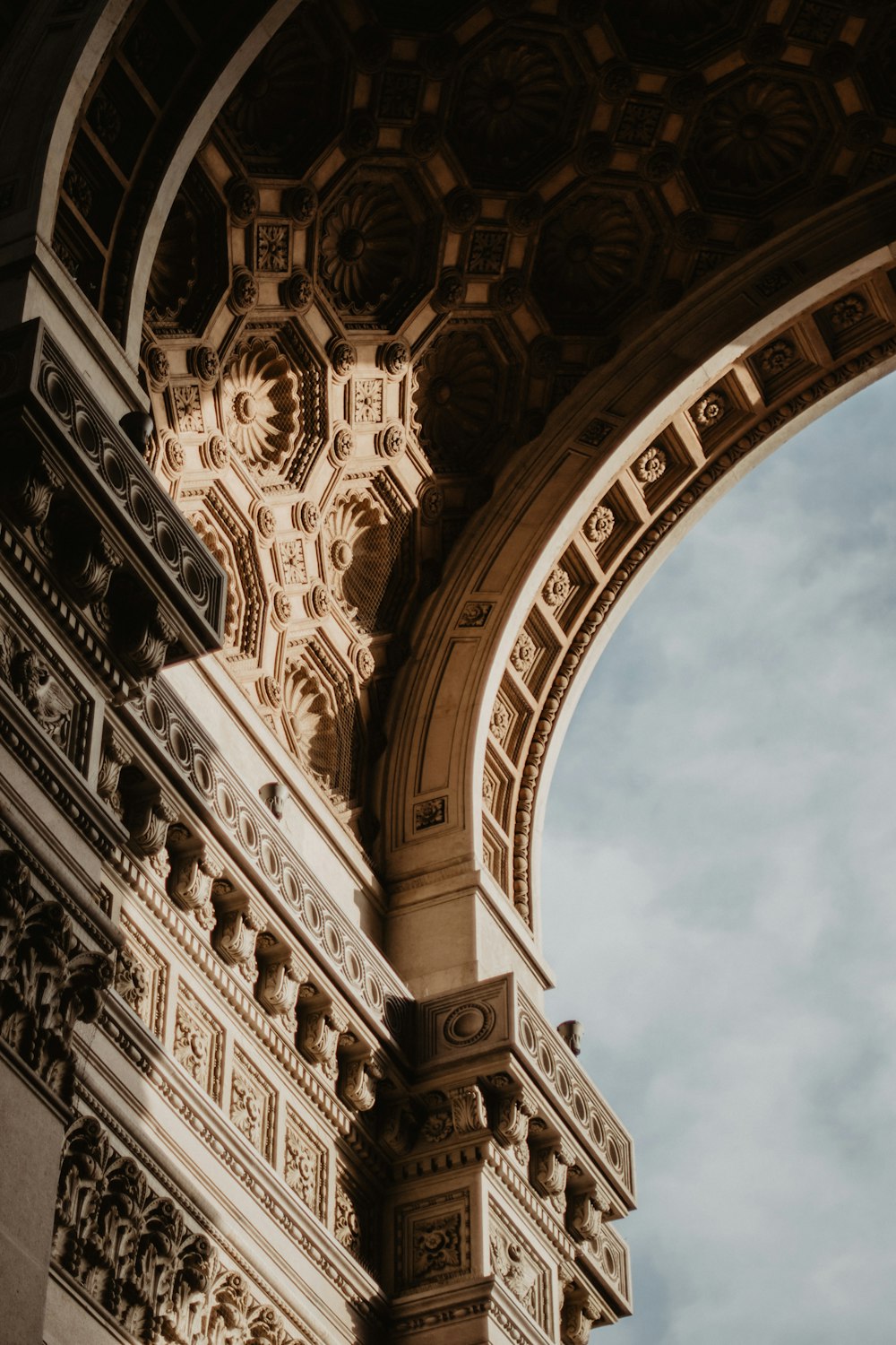 an arch with a clock on the side of it