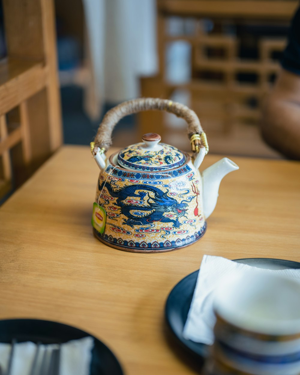 a tea kettle sitting on top of a wooden table