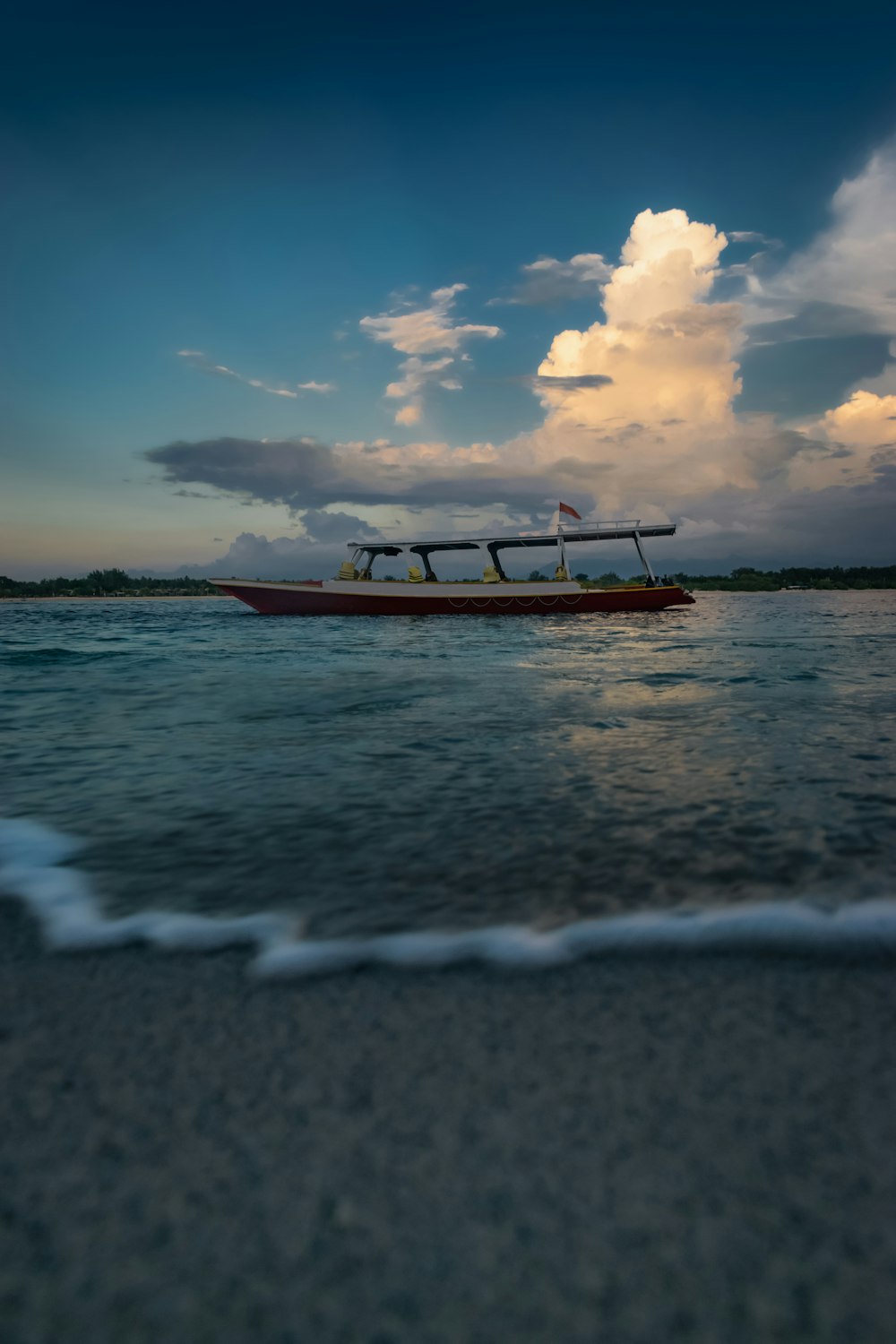 a long boat floating on top of a body of water