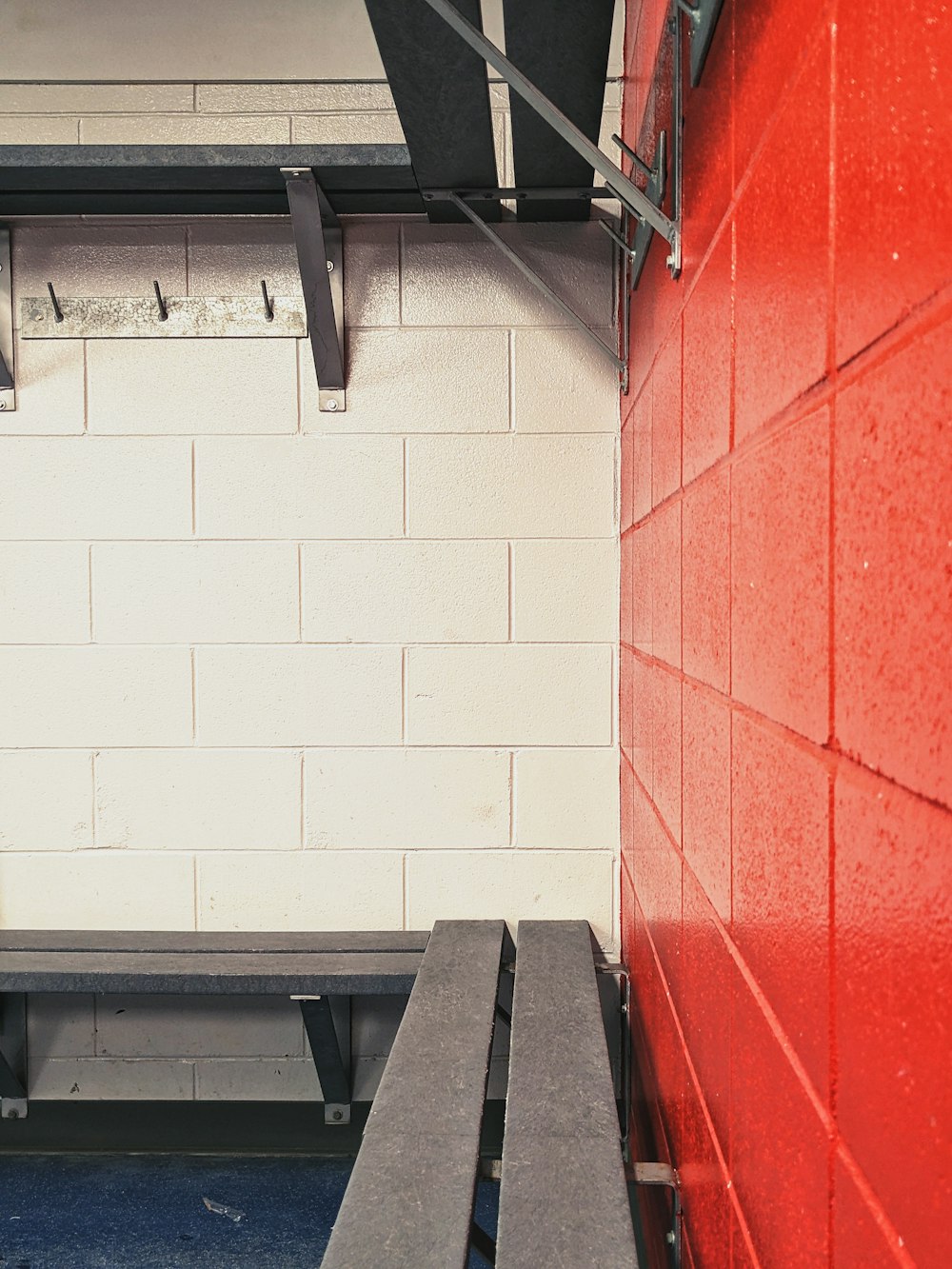 a bench in a room with a red wall