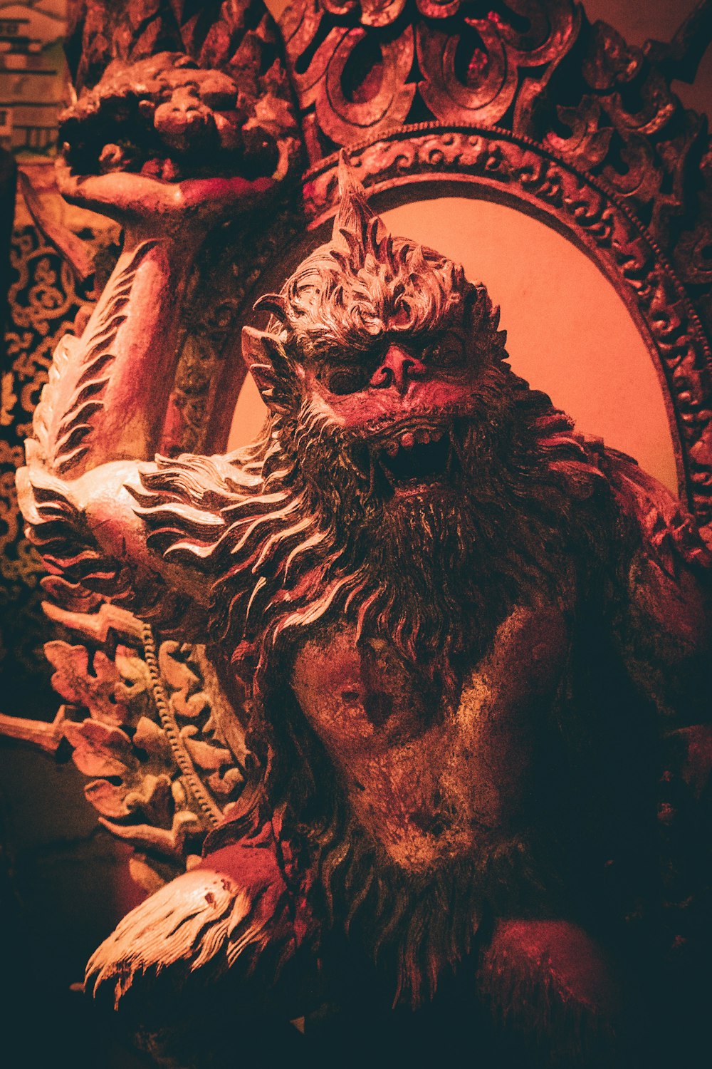 a statue of a monkey sitting in front of a mirror
