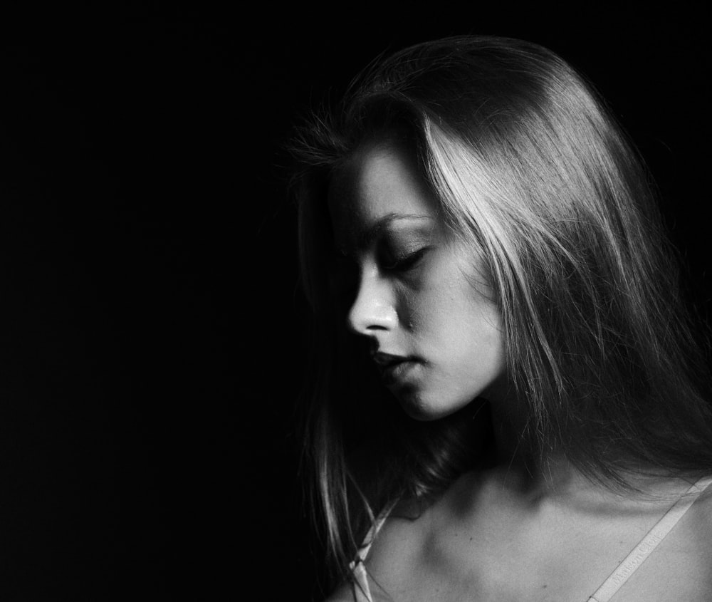 a black and white photo of a woman with long hair