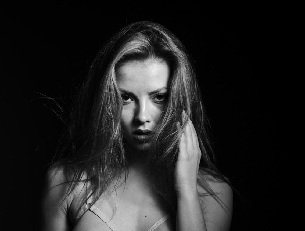 a black and white photo of a woman with long hair