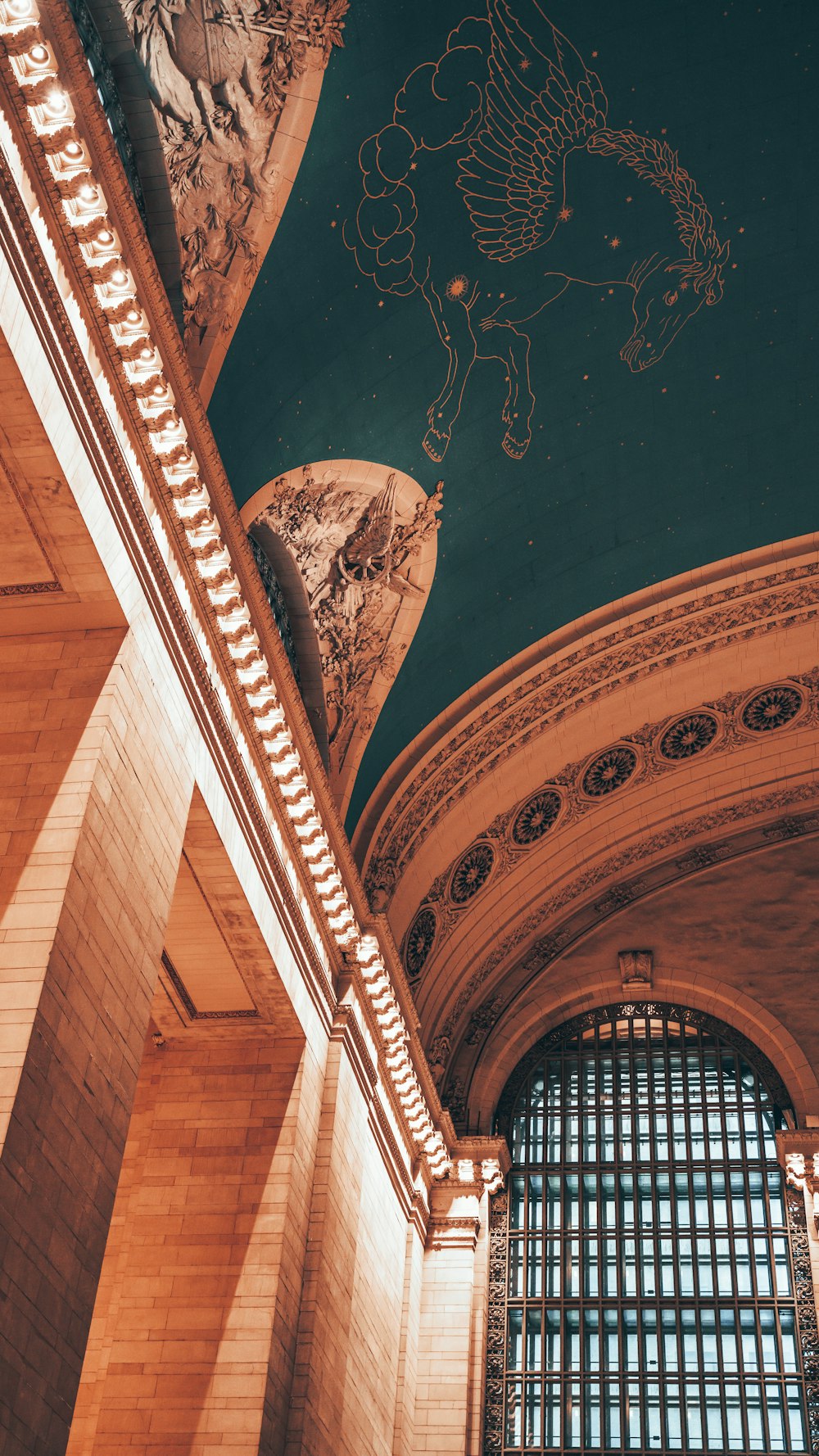 the ceiling of a building with a painting on it