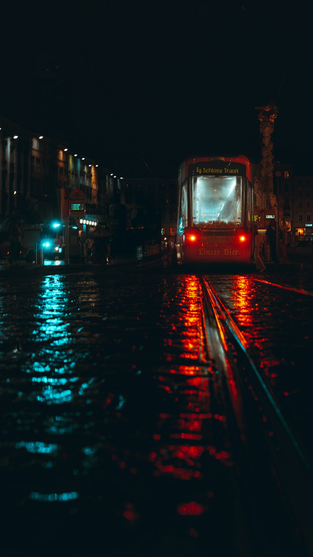 a bus driving down a street at night