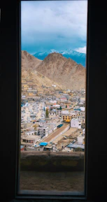 A peaceful view of Helper, Utah’s quaint streets framed by mountains under a clear sky.