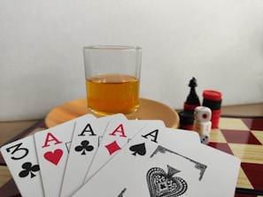 A close-up of a player’s hand confidently placing a winning rummy card on the table.