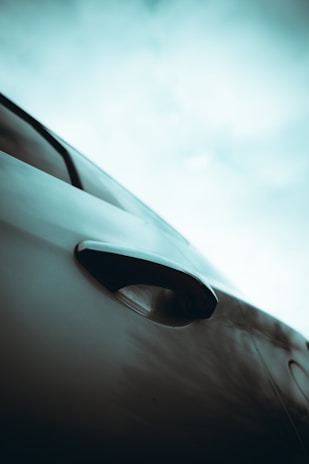 Close-up of a sturdy garage door handle with the Los Angeles skyline blurred in the background.