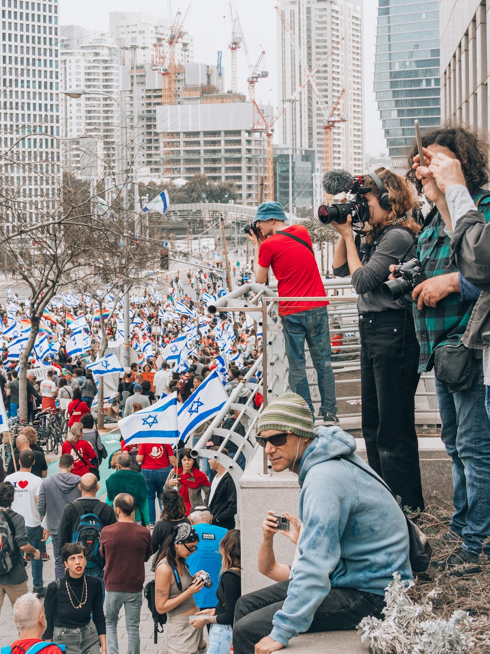 a crowd of people standing around each other