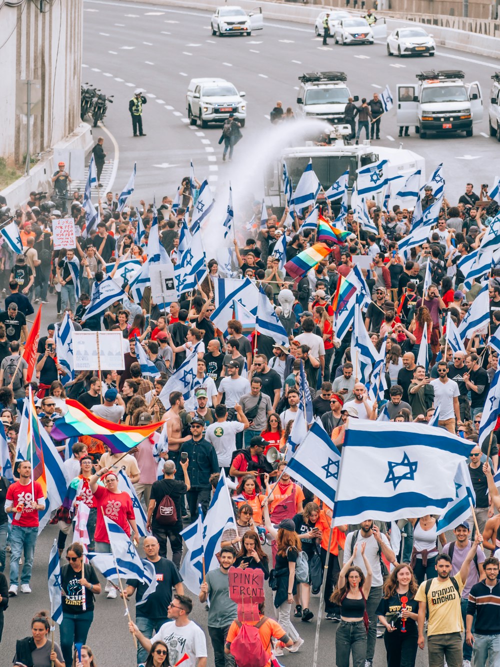 a large group of people walking down a street