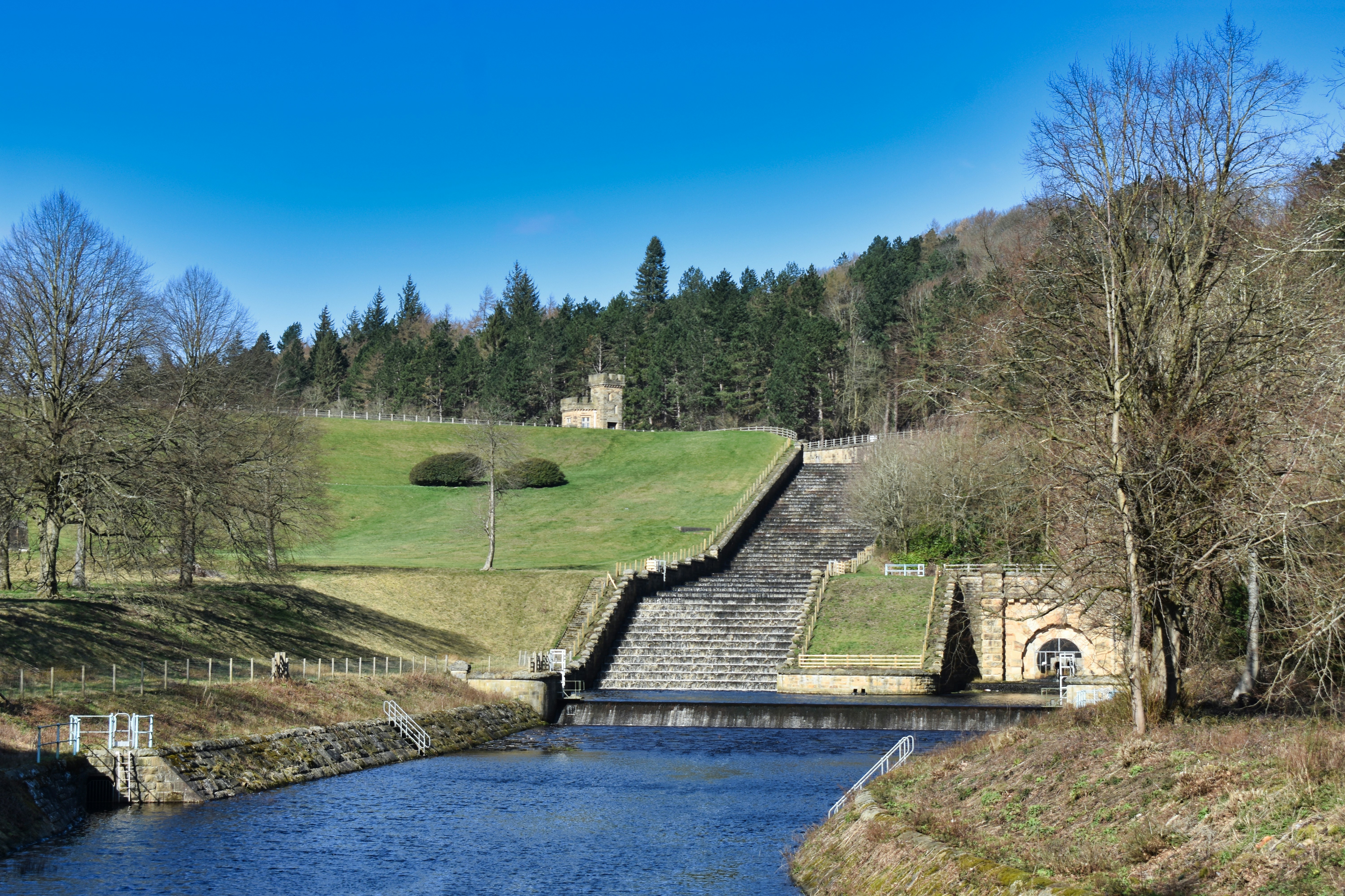 a river running through a lush green countryside