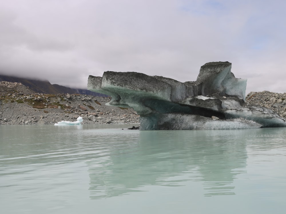 a large iceberg floating on top of a body of water