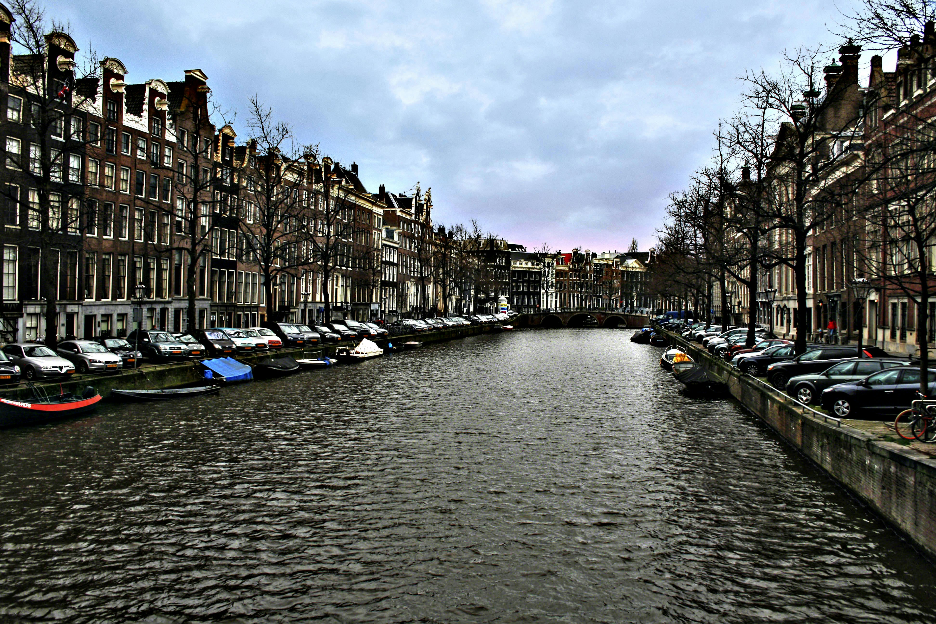 a river running through a city next to tall buildings