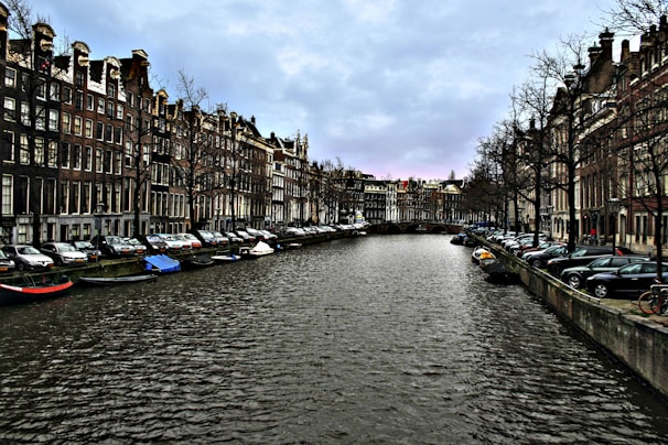 a river running through a city next to tall buildings