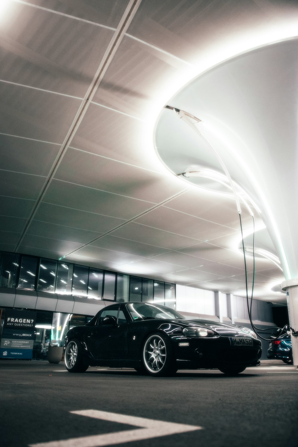 a black car parked in a parking garage