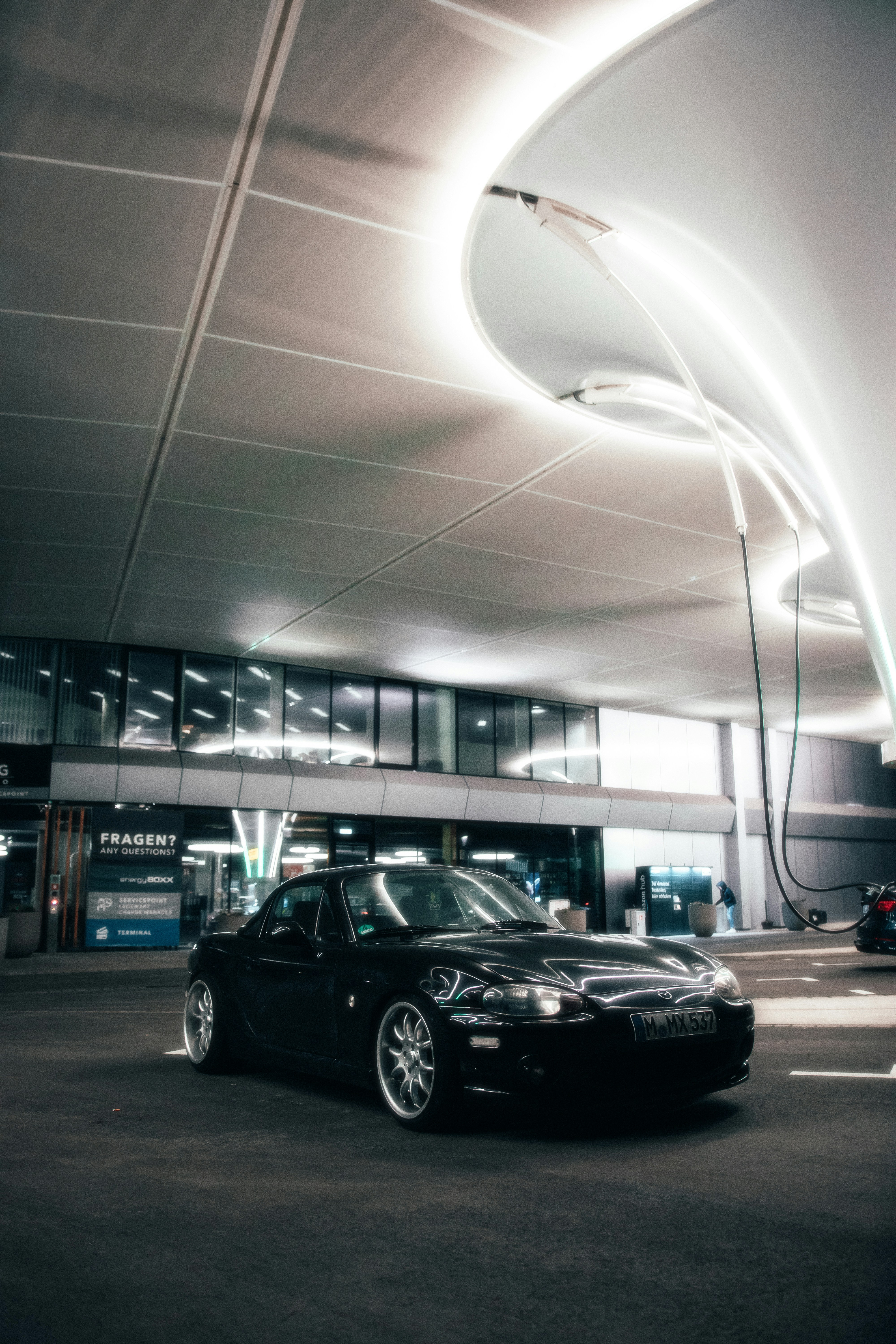 a black car parked in a parking garage