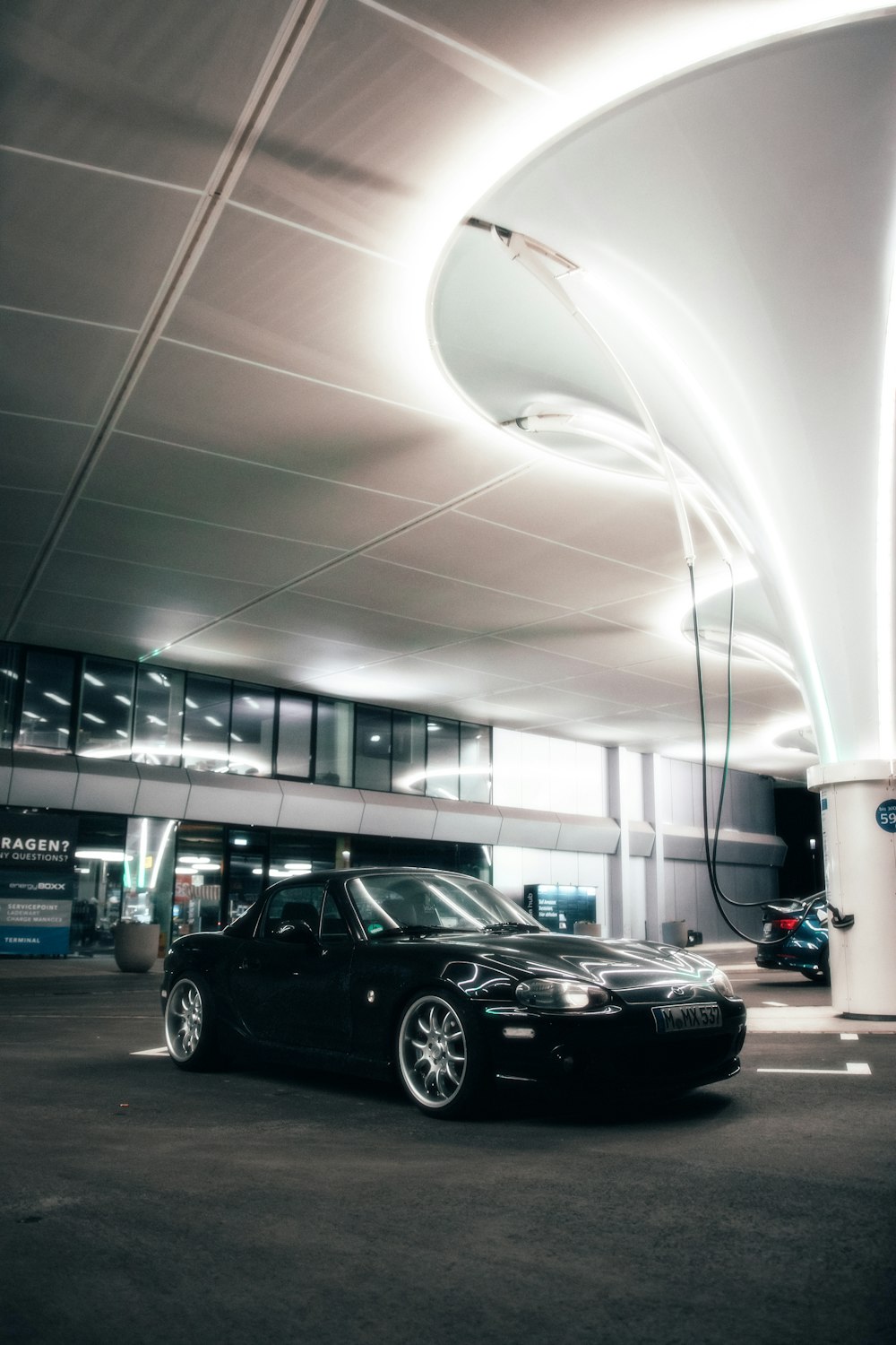 a black car parked in a parking garage