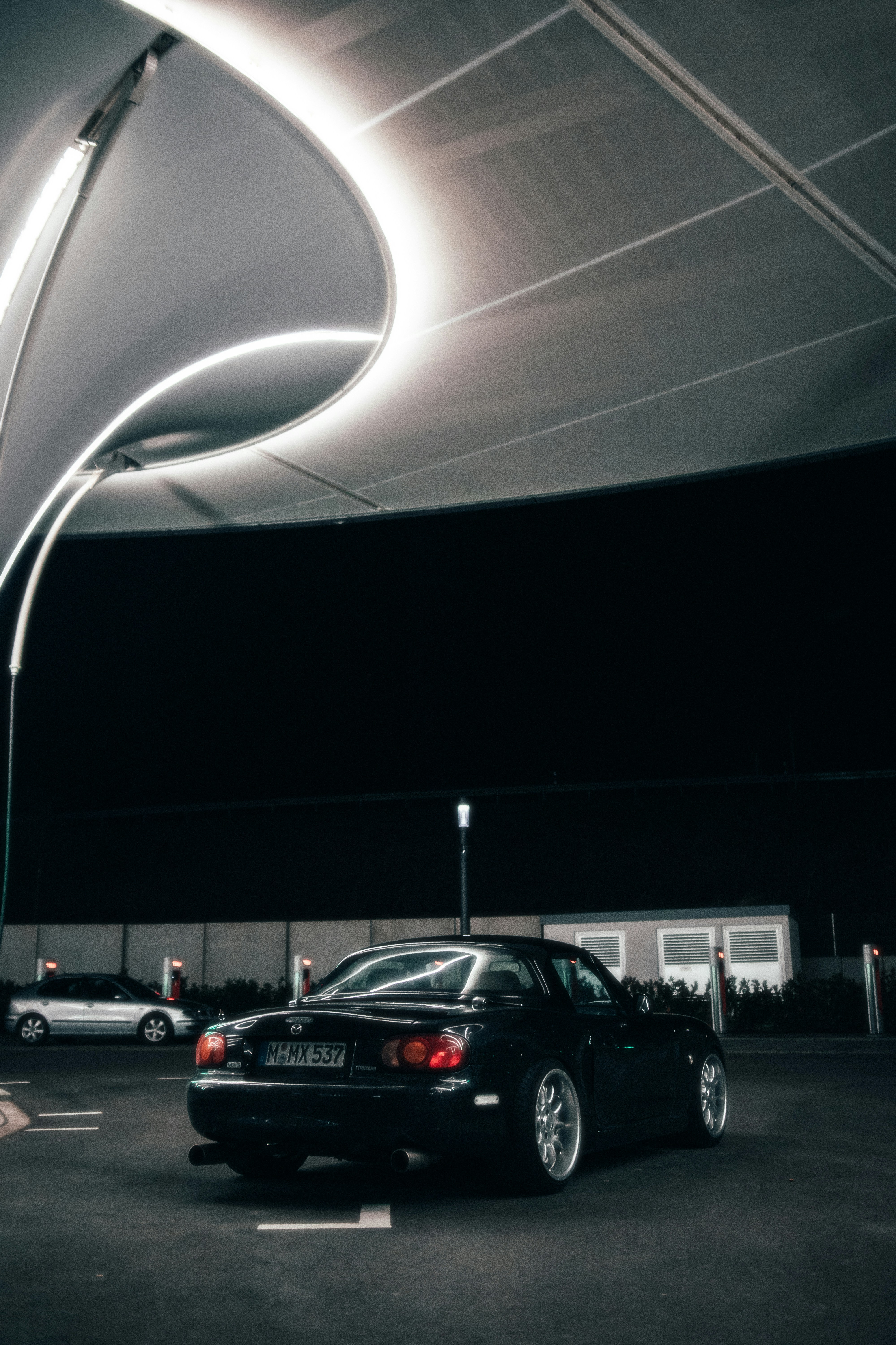 a car is parked in a parking lot at night