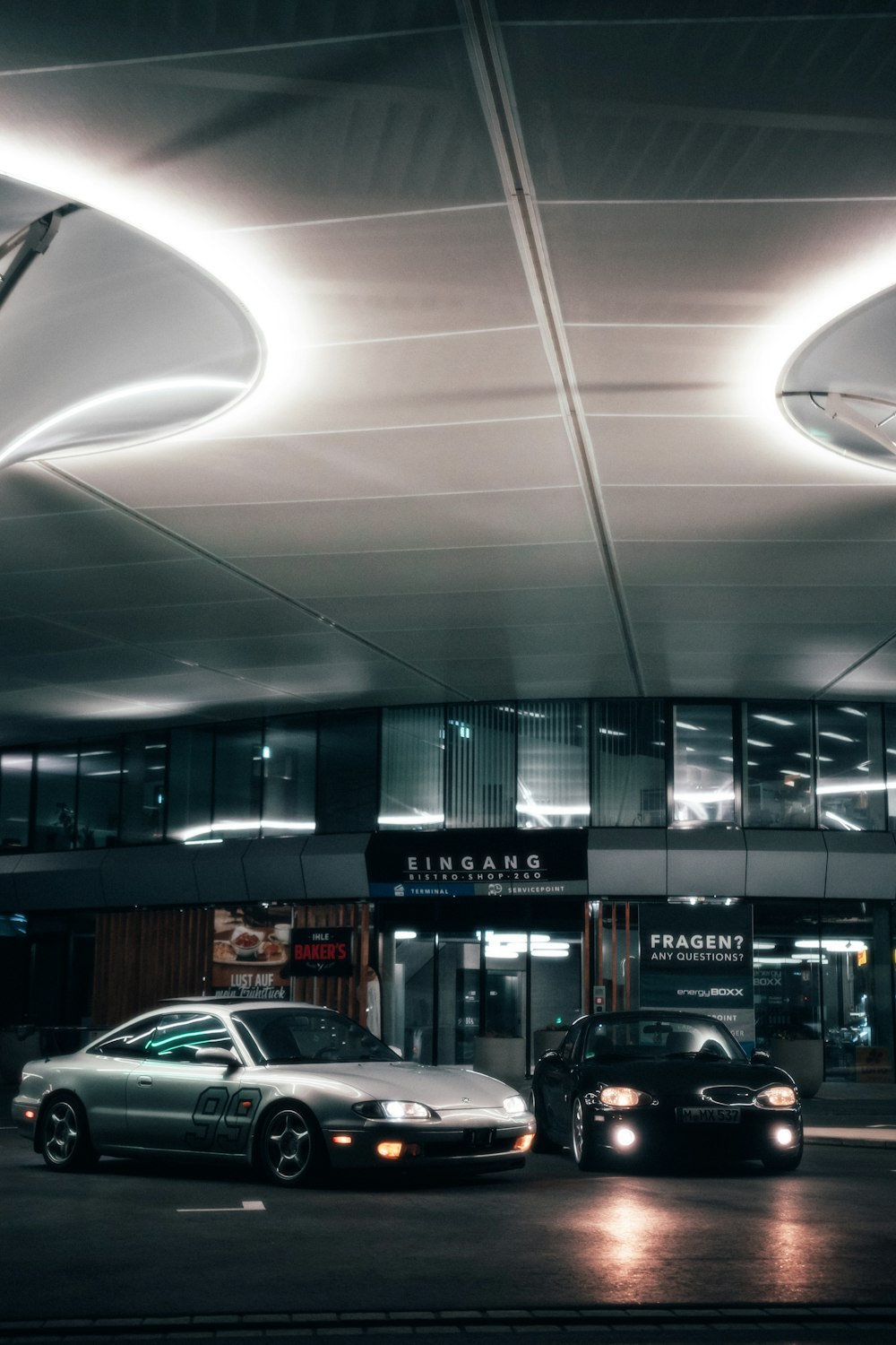 a couple of cars parked in front of a building