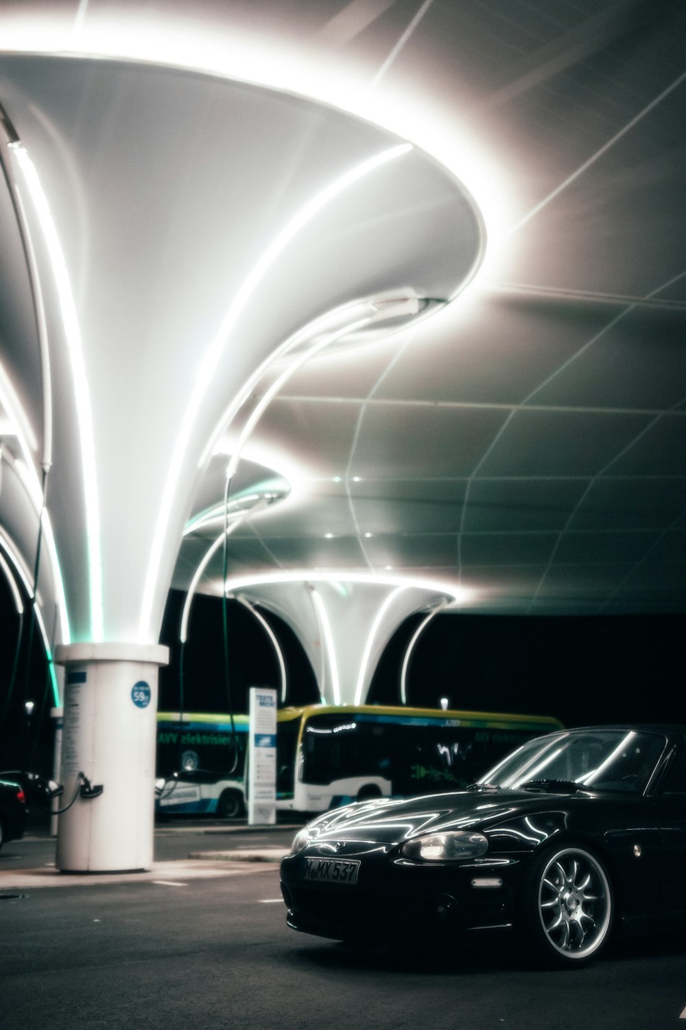 a black car parked in a parking garage