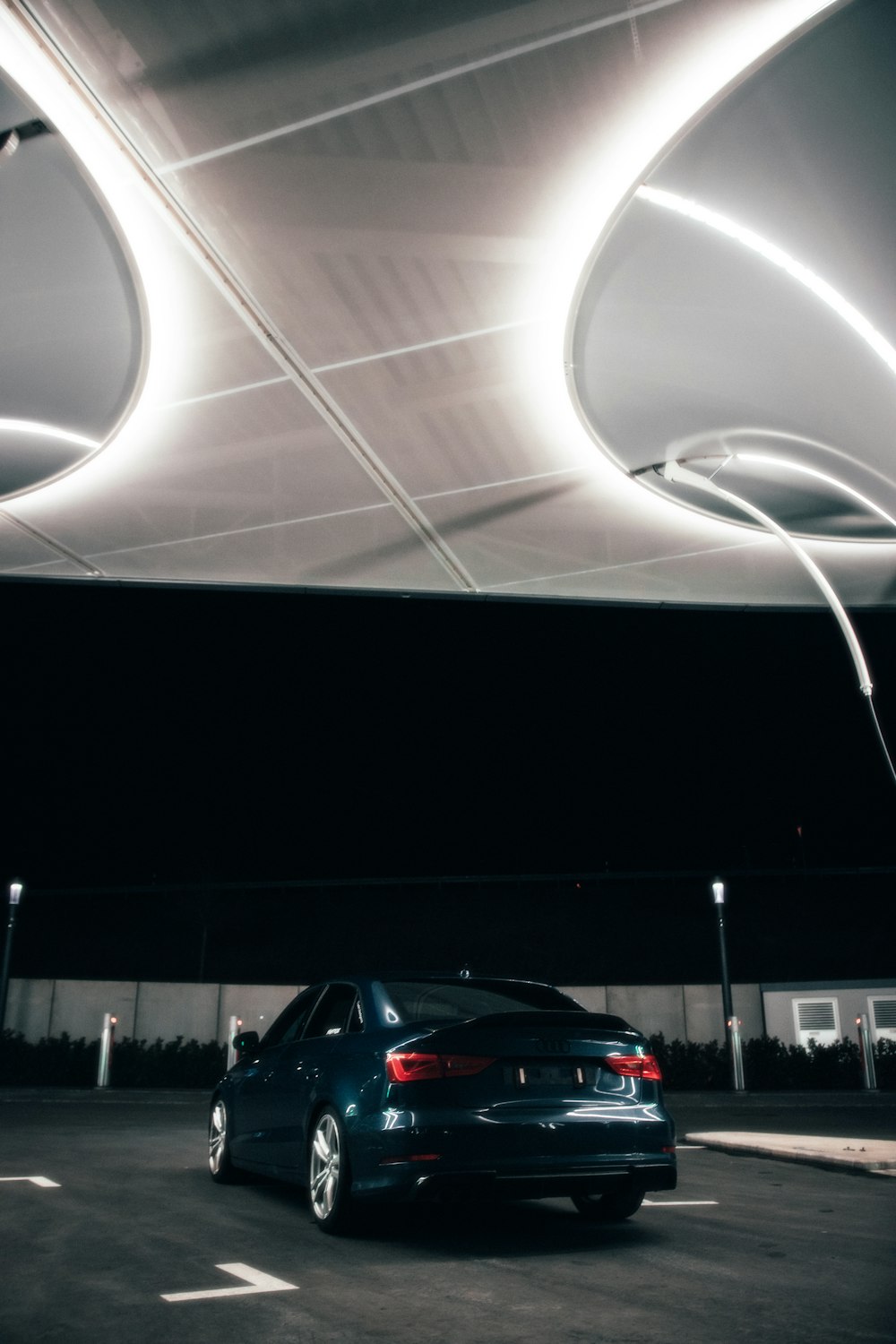 a car parked in a parking lot under a canopy