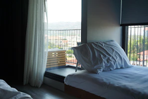 Elegant bedroom in the Sea Terrace with crisp white linens and minimalist decor.