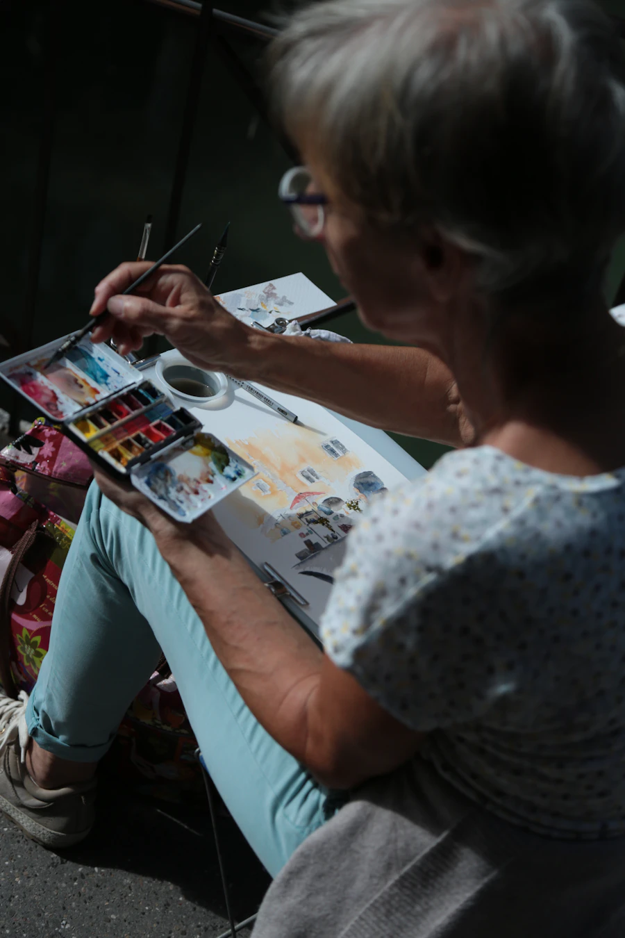A senior woman focused and joyful while painting