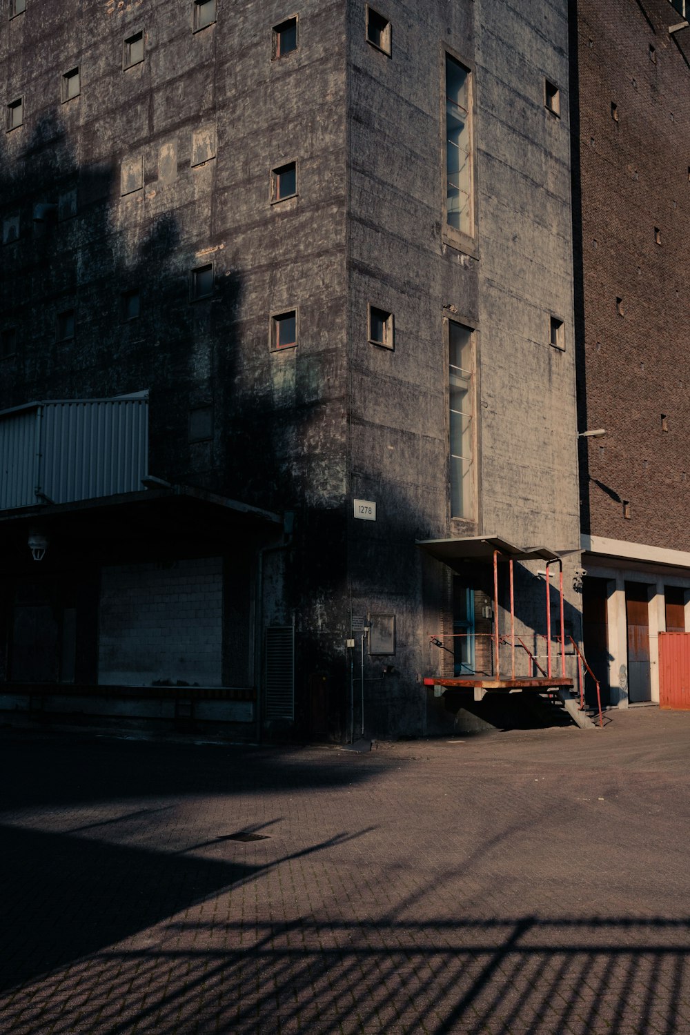 an empty parking lot in front of a tall building