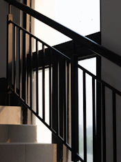 A dramatic architectural staircase bathed in soft natural light.