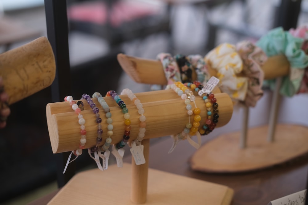 a display of bracelets on a wooden stand
