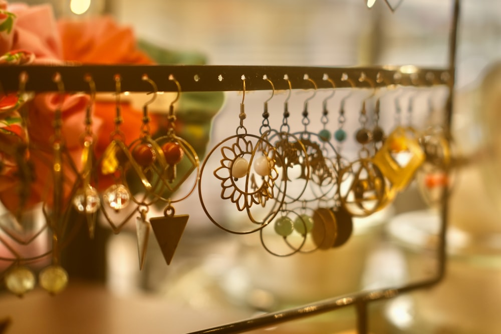 a bunch of earrings are hanging on a rack