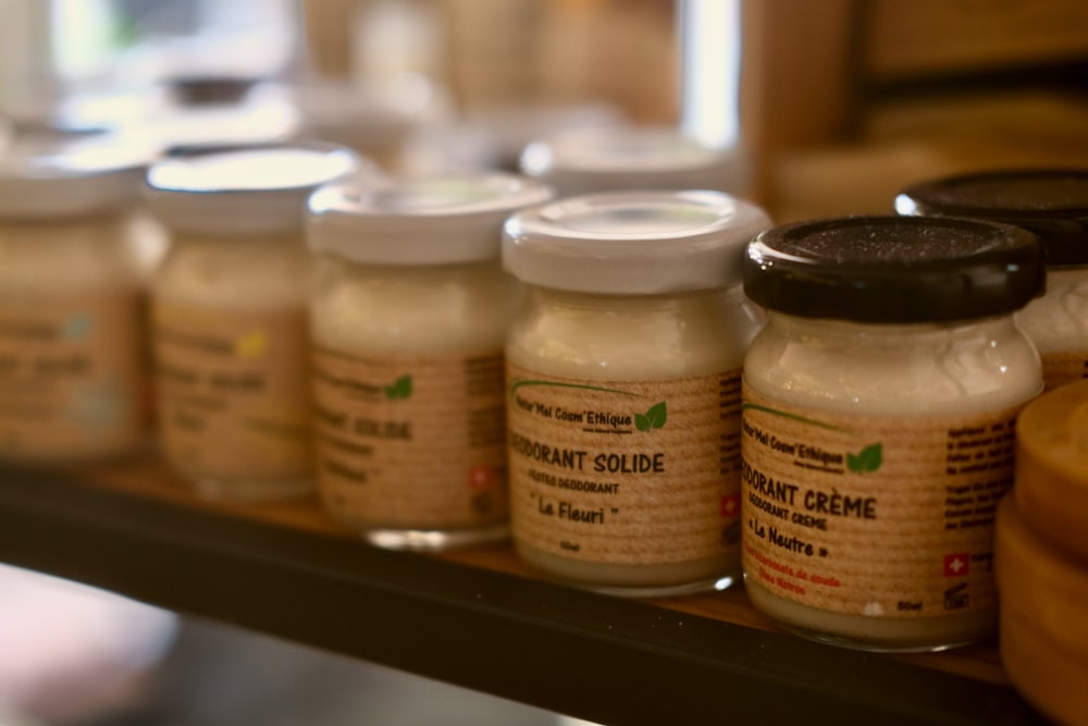 a row of jars of peanut butter on a shelf