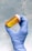 A happy customer holding a pill bottle with a smile.
