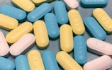 A close-up of hormone replacement therapy medication carefully arranged on a soft pastel background.