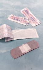 A close-up of various adhesive products on a workbench.