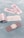 Several adhesive bandages and their packaging are placed on a light blue surface. The bandages are surrounded by opened and unopened wrappers that display the word 'BANDAGE' in red.
