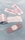 Several adhesive bandages and their packaging are placed on a light blue surface. The bandages are surrounded by opened and unopened wrappers that display the word 'BANDAGE' in red.