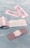 Several adhesive bandages and their packaging are placed on a light blue surface. The bandages are surrounded by opened and unopened wrappers that display the word 'BANDAGE' in red.