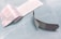 An opened adhesive bandage is lying on a light blue surface. The bandage is partially unwrapped, revealing a white pad on one side. The wrapper features text and branding details. Next to the bandage is the paper backing that has been removed.