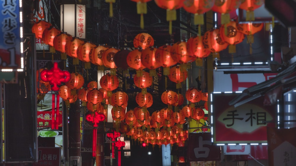 a bunch of red lanterns hanging from a ceiling