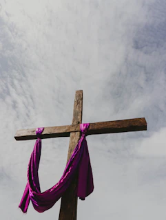 a cross with a purple cloth draped around it
